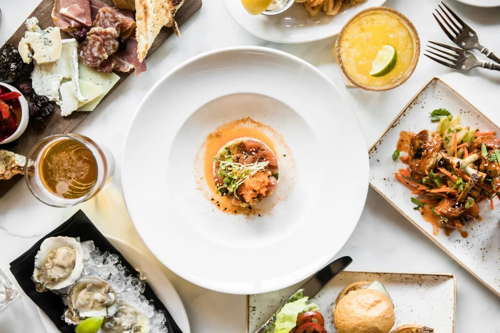 Table with plates of food and drinks seen from above