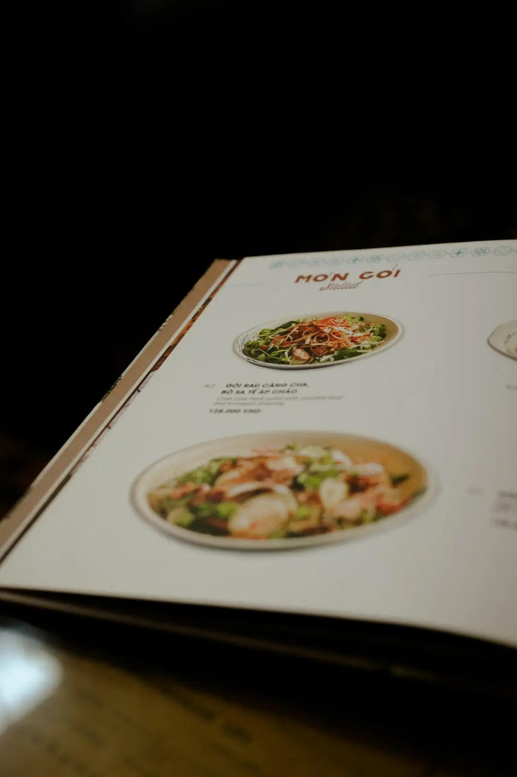 Open printed menu on a wooden table