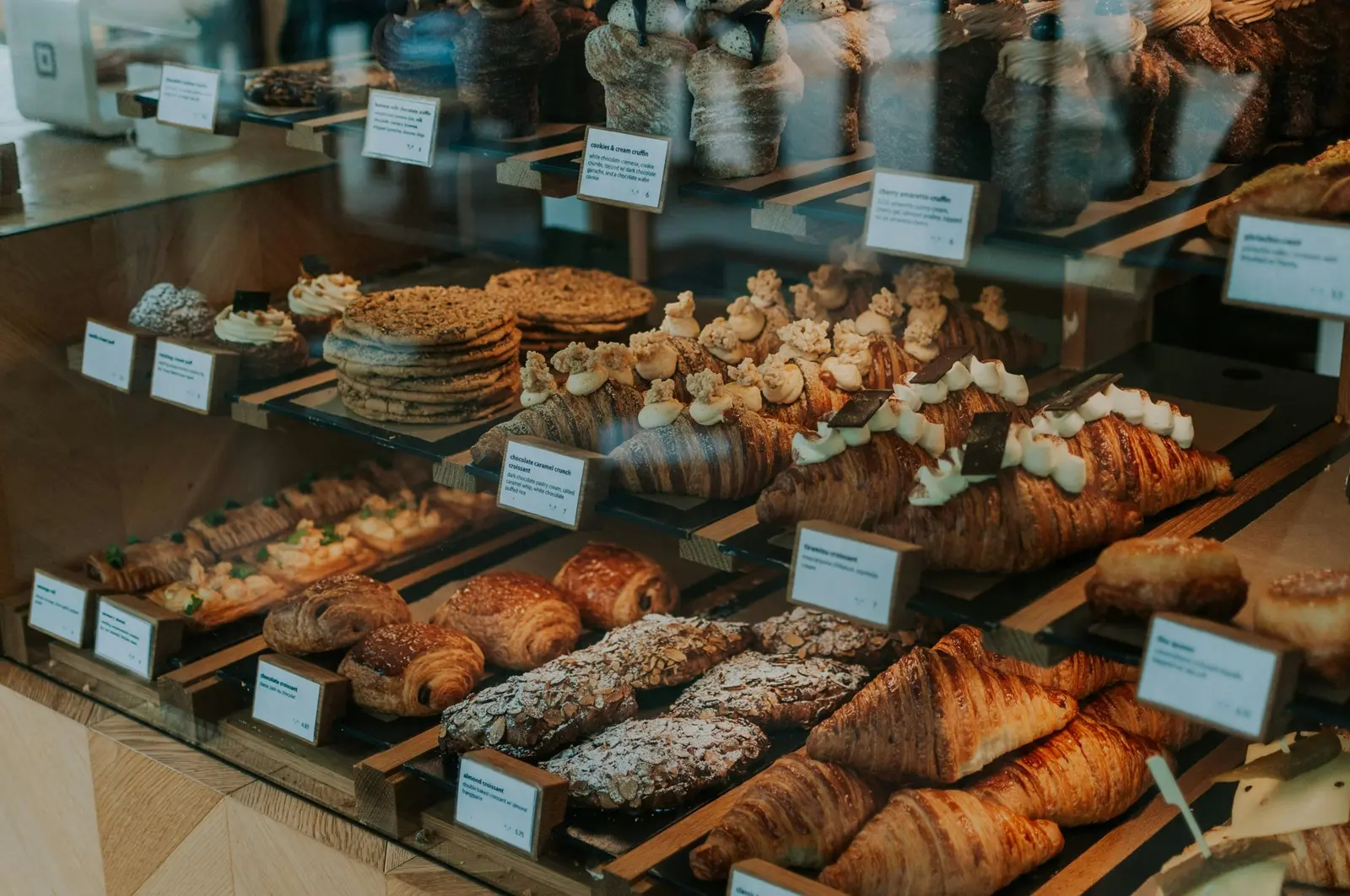Pastry display case with croissants and baked goods
