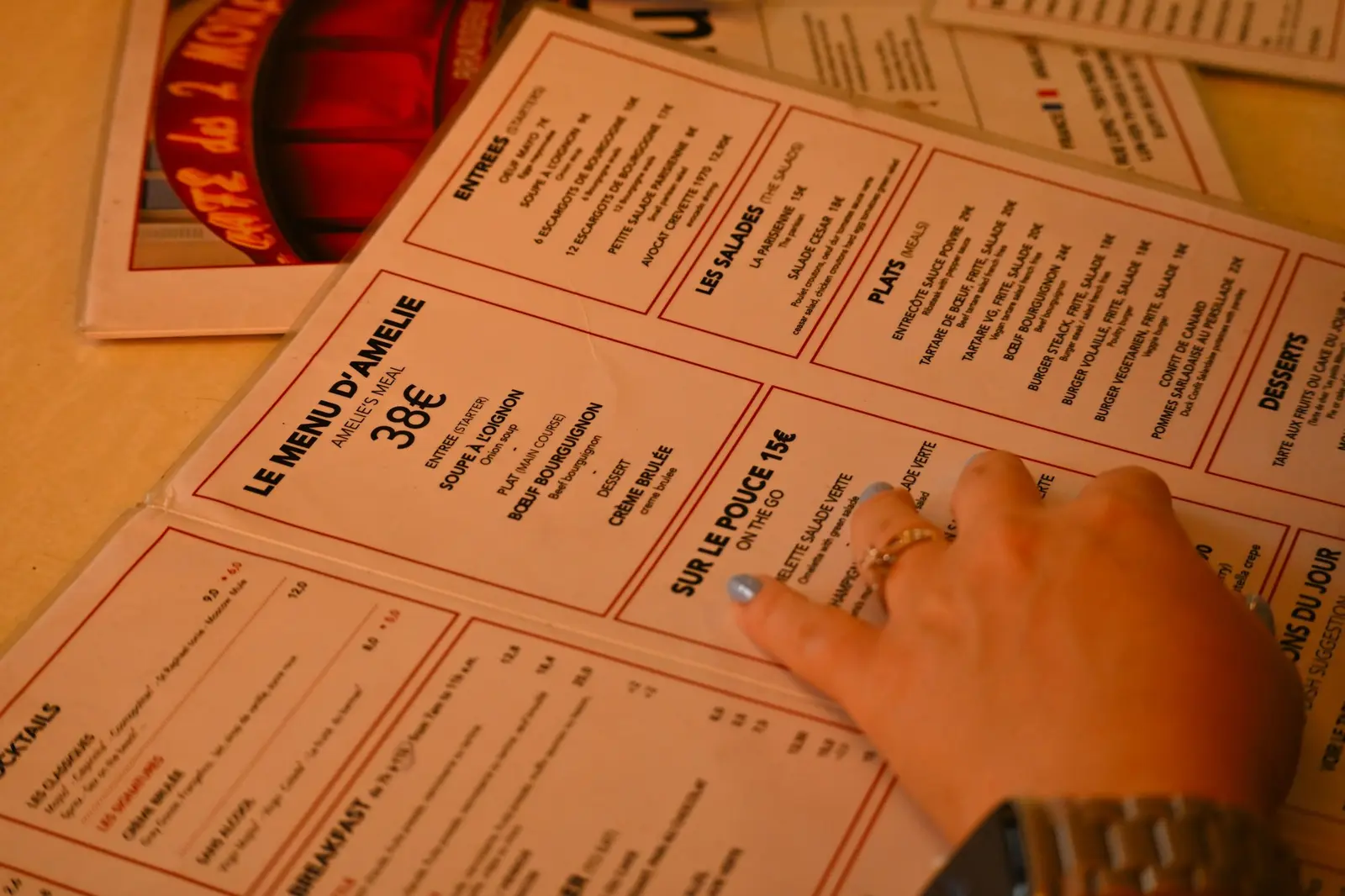 Guest's hand resting on a printed restaurant menu